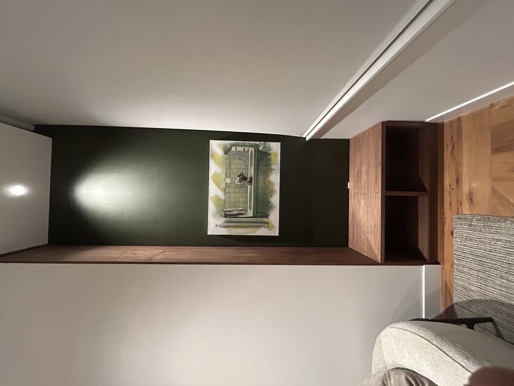 Built-in walnut floating shelf with reclaimed wood accent wall