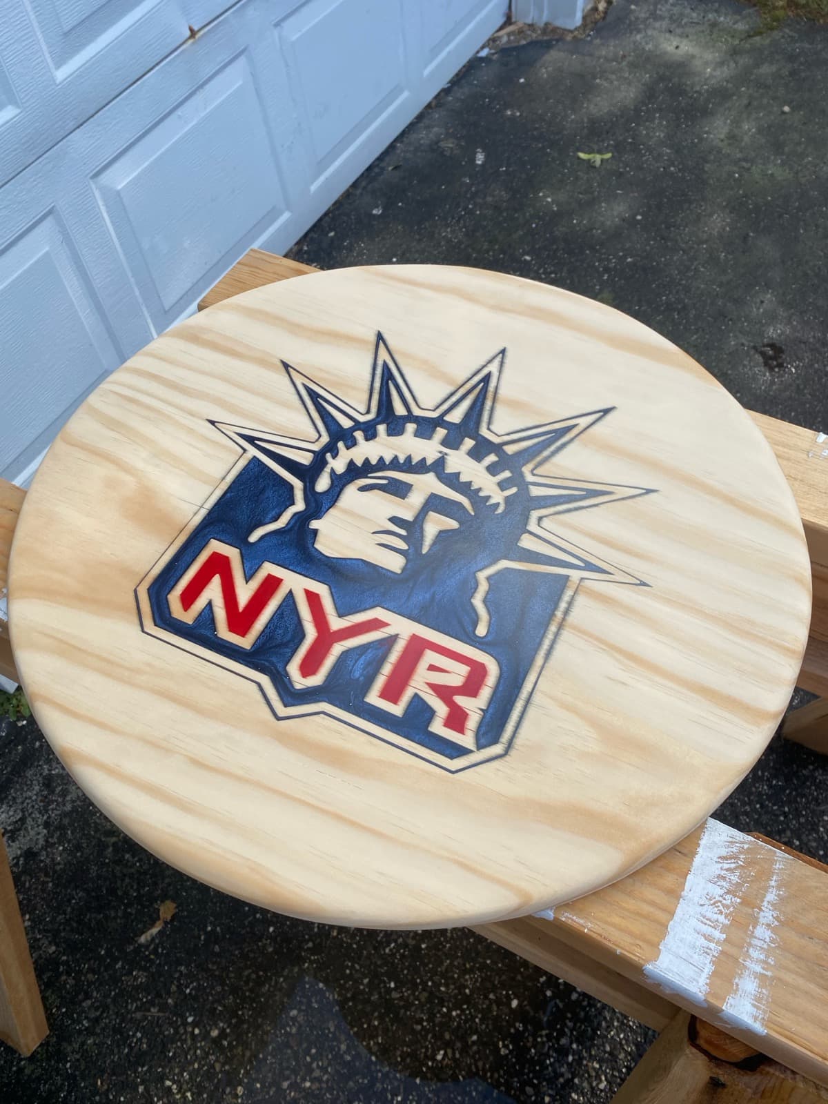 Carved NY Rangers Statue of Liberty logo on a round wood plaque