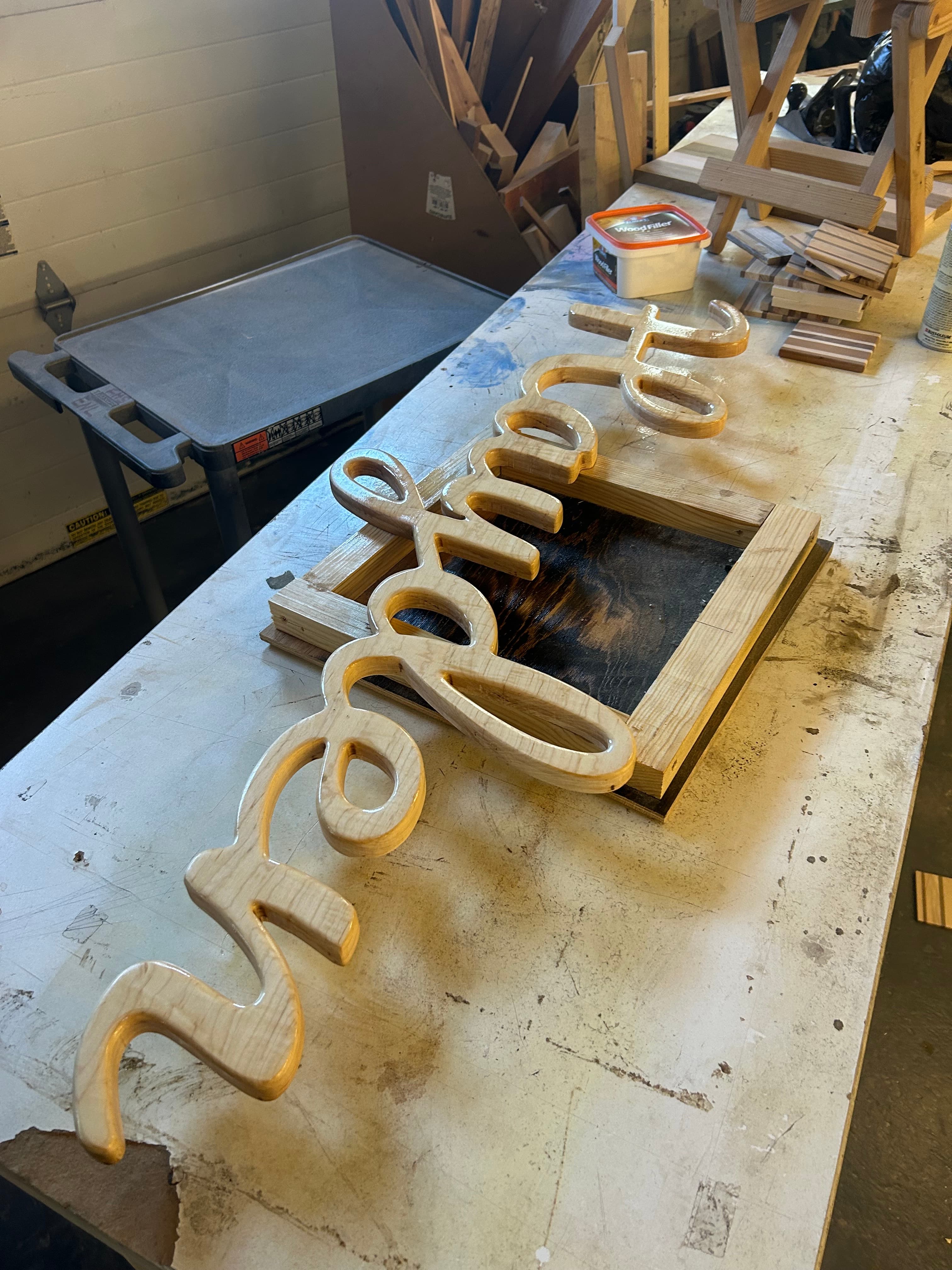 Custom CNC-cut cursive name sign in natural wood