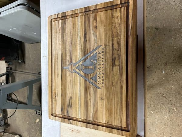Custom engraved teak cutting board with business logo