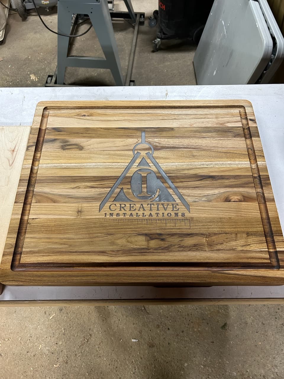 Custom engraved teak cutting board with business logo