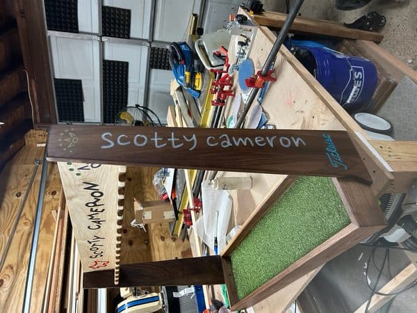 Custom walnut golf putter display rack close-up detail view