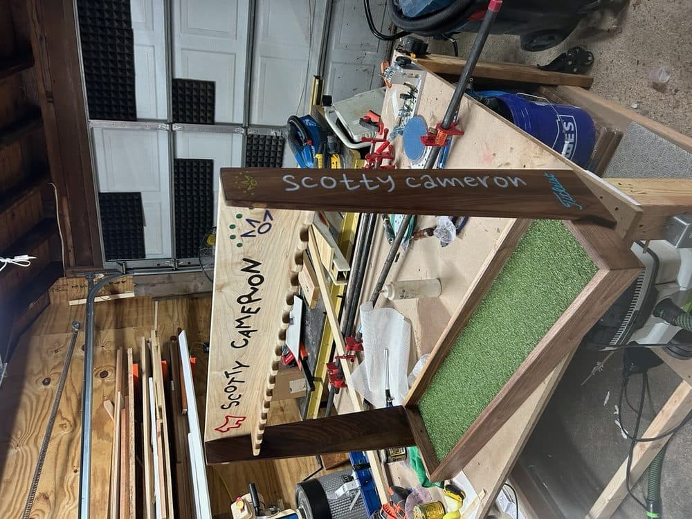 Custom walnut golf putter display rack showing full wide view