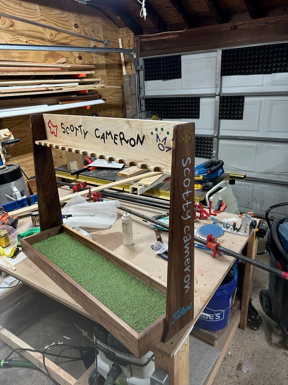Custom walnut golf putter display rack showing full wide view