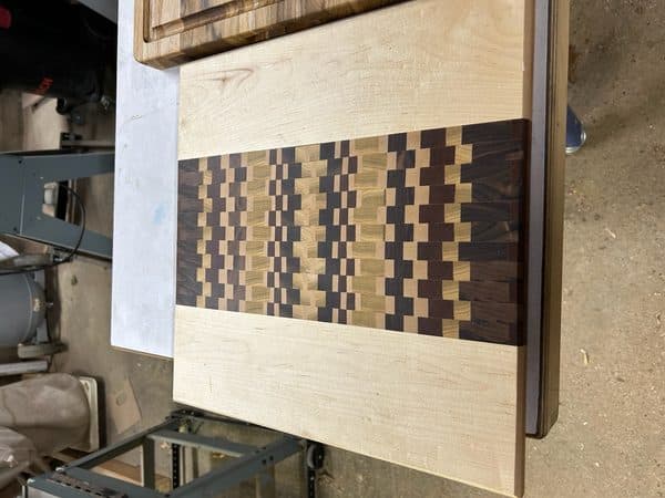 End-grain mosaic pattern cutting board in maple and walnut