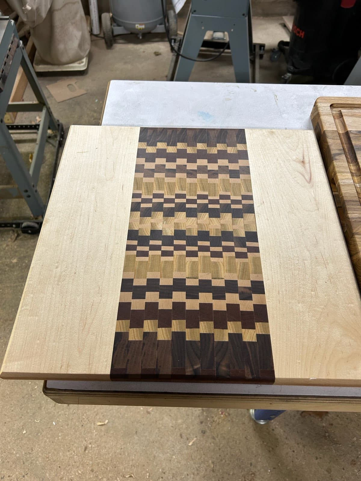 End-grain mosaic pattern cutting board in maple and walnut