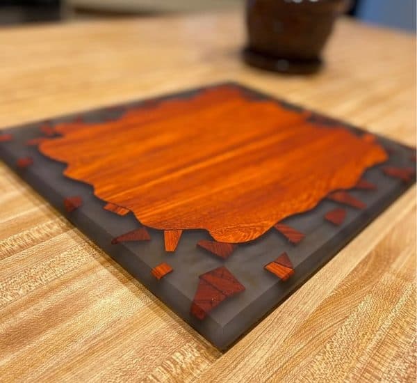 Exotic wood serving board with dark epoxy resin accent