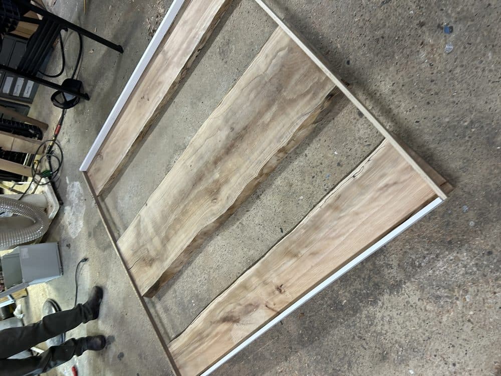 Live edge walnut shelving panels mounted on industrial metal frame