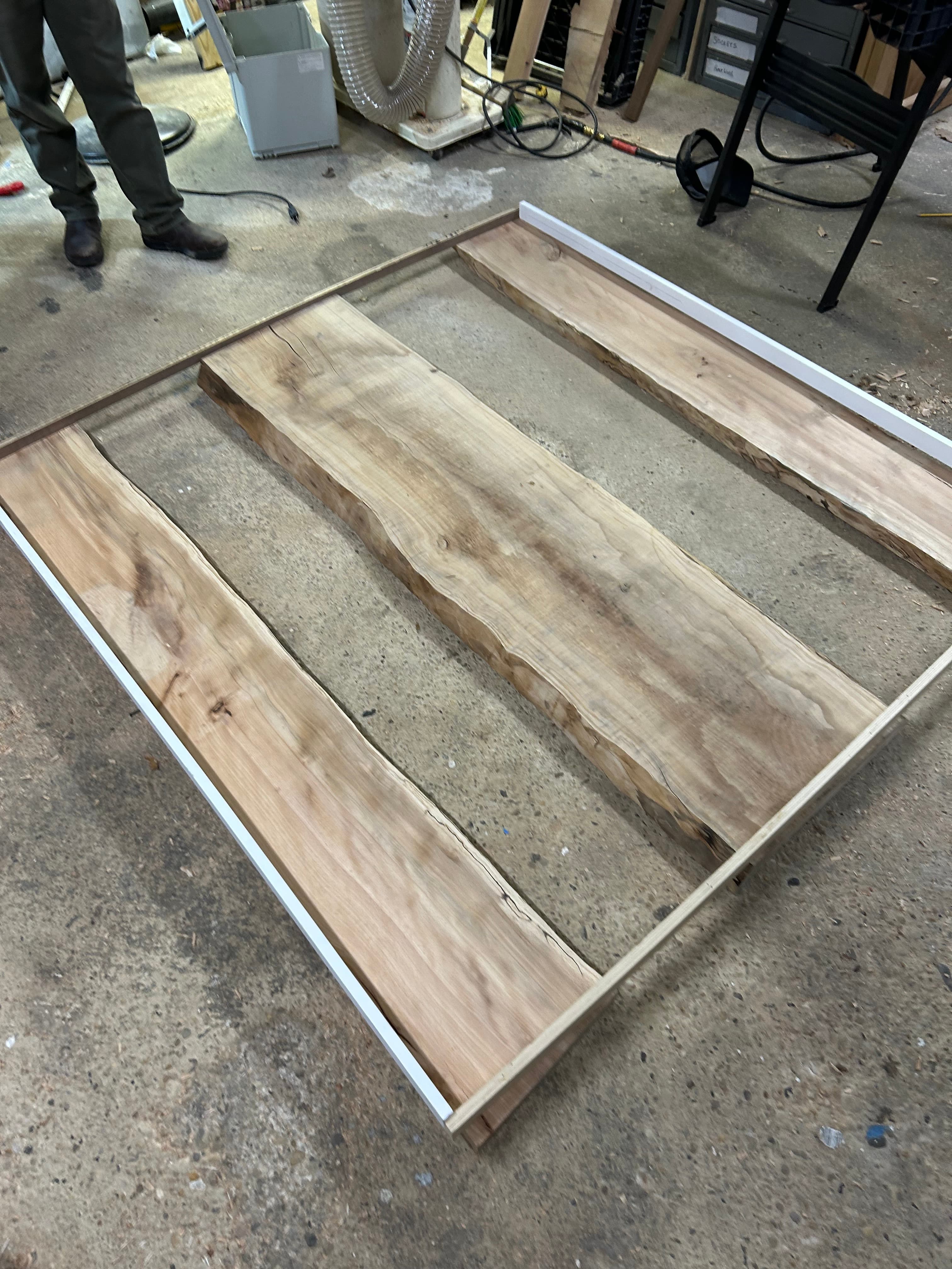 Live edge walnut shelving panels mounted on industrial metal frame