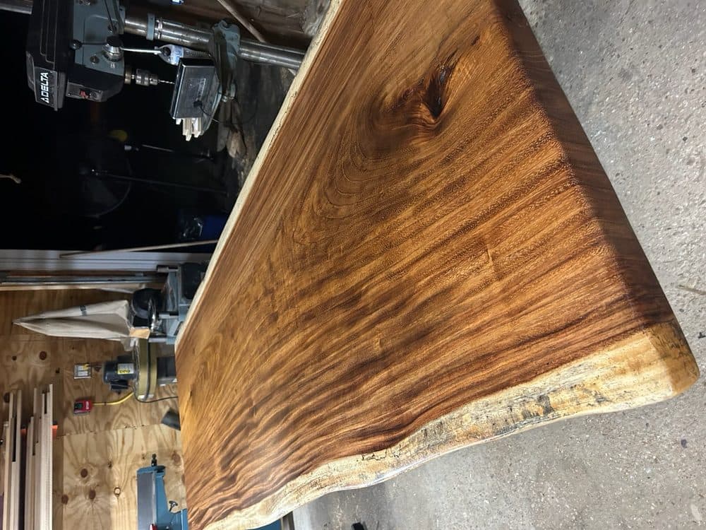Finished live edge walnut slab with smooth sanded surface and natural bark edge
