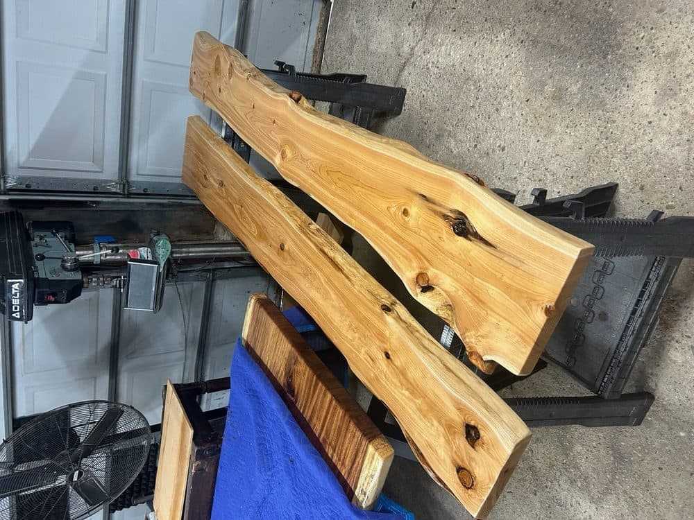 Live edge wood slab shelves being prepared in the workshop