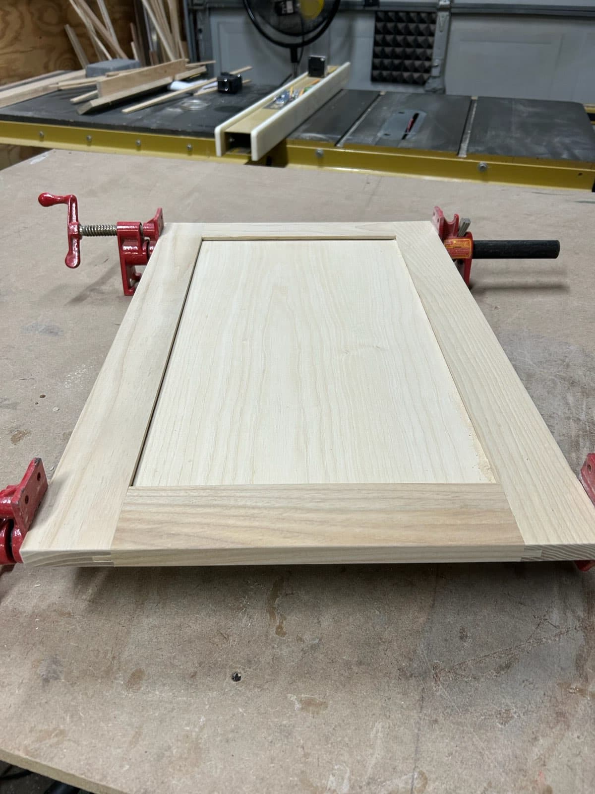 Maple shaker style raised panel cabinet door in workshop