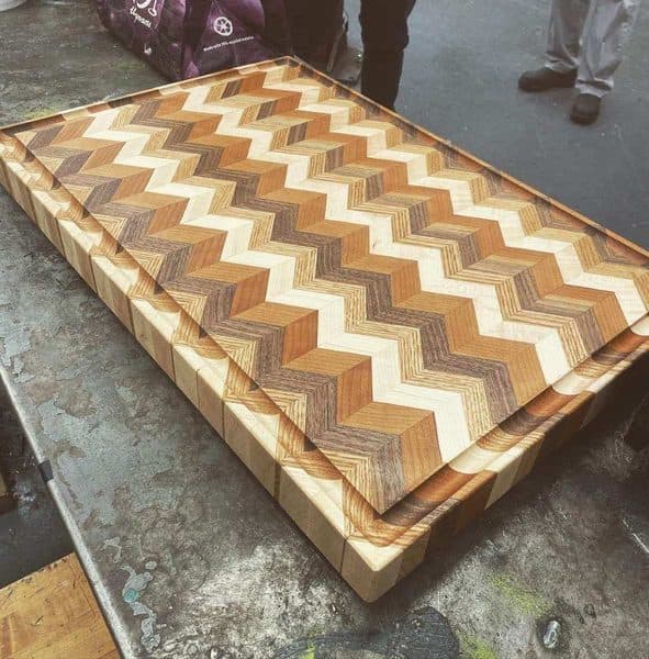 End grain cutting board with chevron pattern