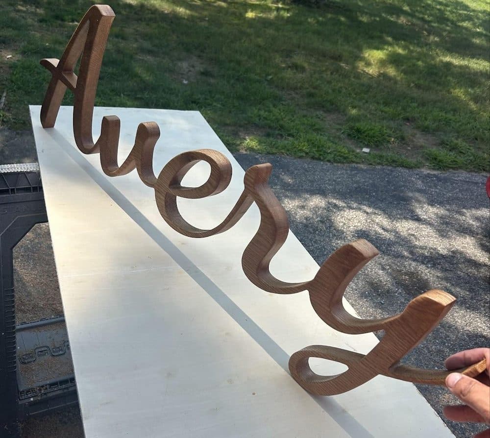 Cursive freestanding wood name sign spelling Avery