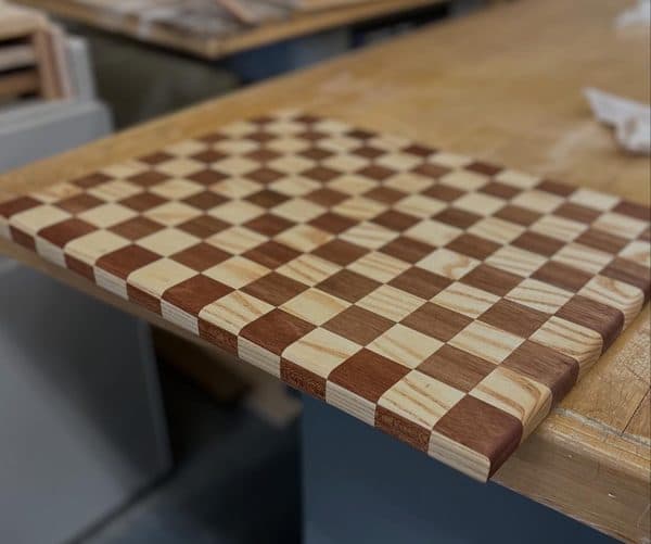 Checkerboard pattern cutting board doubling as a chess board