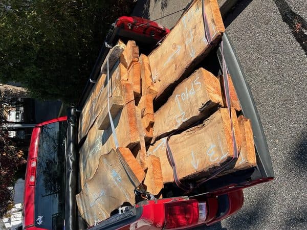 Raw live edge wood slabs being delivered on a truck