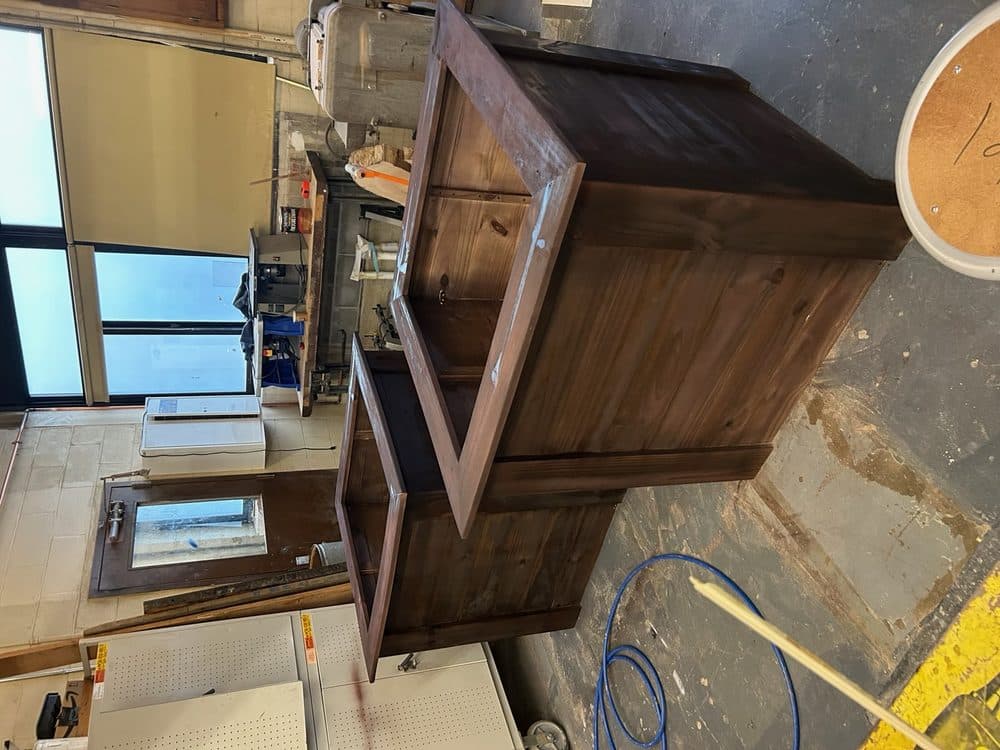 Rustic stained pine storage cabinet with custom hardware